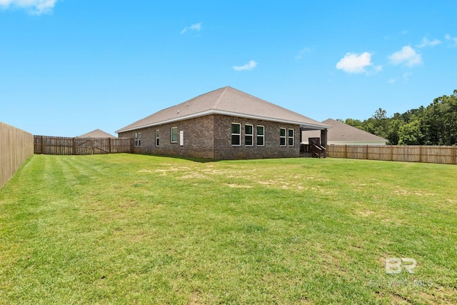 back of property featuring a yard