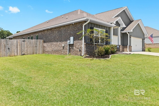 view of side of property featuring a garage and a yard