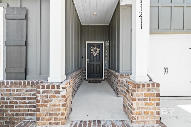 view of exterior entry with a garage