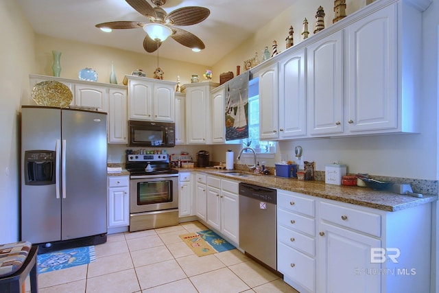 1912 Brigadoon Trl, Gulf Shores, AL 36542 - kitchen featuring appliances with stainless steel finishes, a sink, white cabinetry, a ceiling fan, and light tile patterned floors