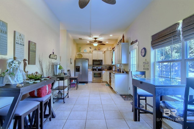 1912 Brigadoon Trl, Gulf Shores, AL 36542 - kitchen featuring appliances with stainless steel finishes, a ceiling fan, light tile patterned floors, and light countertops