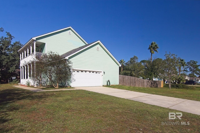 1912 Brigadoon Trl, Gulf Shores, AL 36542 - view of side of home with a balcony, driveway, and an attached garage