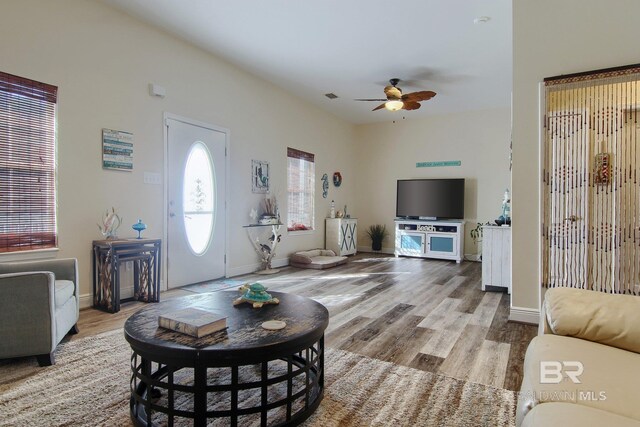 1912 Brigadoon Trl, Gulf Shores, AL 36542 - living area featuring ceiling fan, wood finished floors, and baseboards