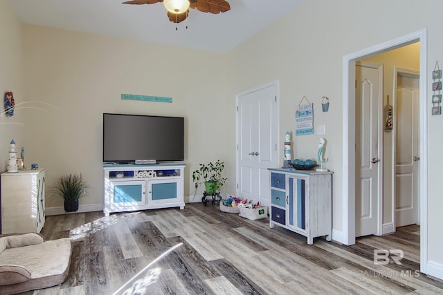 1912 Brigadoon Trl, Gulf Shores, AL 36542 - living area featuring ceiling fan, wood finished floors, and baseboards