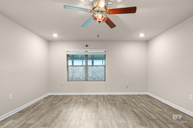 unfurnished room with recessed lighting, wood finished floors, and baseboards