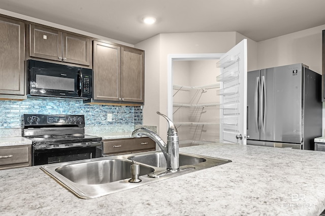 kitchen with tasteful backsplash, black appliances, and light countertops