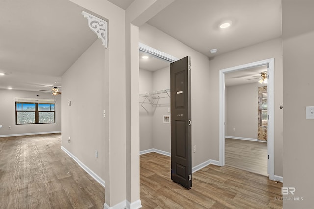 hallway with baseboards and wood finished floors