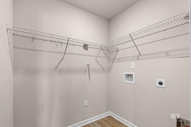 laundry room featuring wood finished floors, baseboards, hookup for an electric dryer, hookup for a washing machine, and laundry area