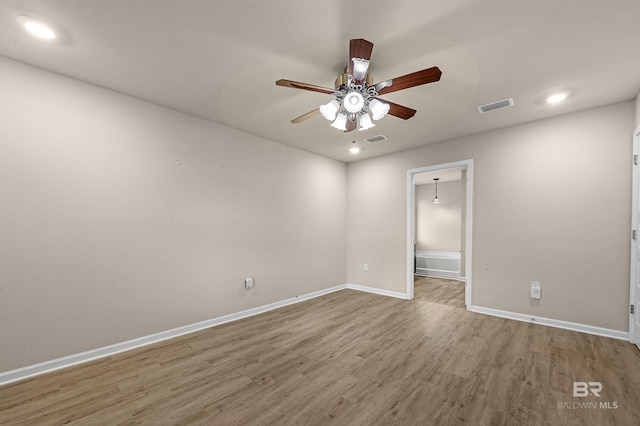 unfurnished room with recessed lighting, visible vents, baseboards, and wood finished floors