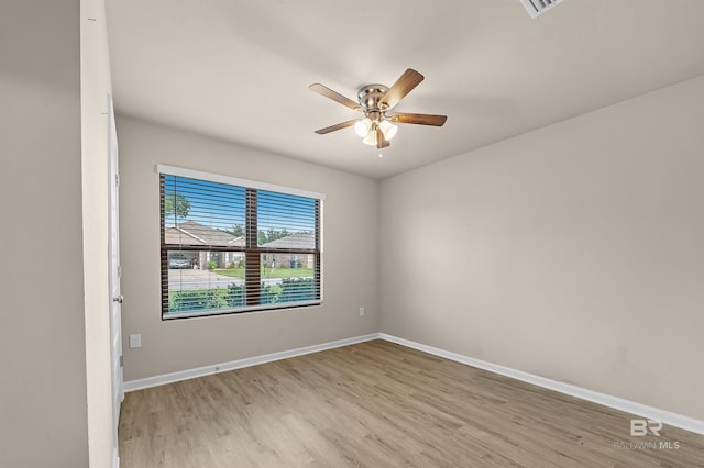 empty room with baseboards, light wood-style floors, and a ceiling fan