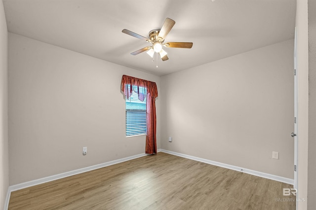 empty room featuring a ceiling fan, light wood-style floors, and baseboards