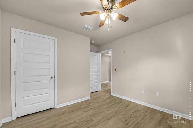 unfurnished bedroom with visible vents, a ceiling fan, light wood-type flooring, and baseboards