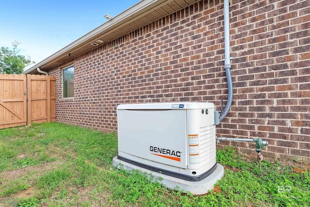 exterior details with fence, brick siding, and a power unit