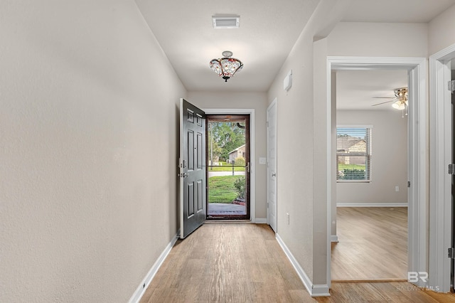 entrance foyer with visible vents, light wood-type flooring, and baseboards