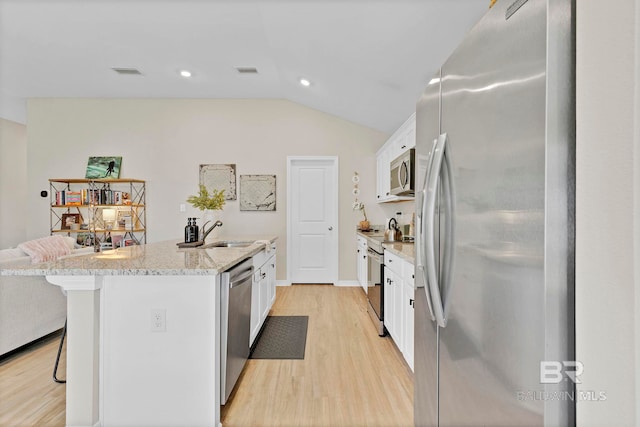 1203 Hayward Loop, Foley, AL 36535 - kitchen featuring a sink, white cabinetry, visible vents, a kitchen breakfast bar, and appliances with stainless steel finishes