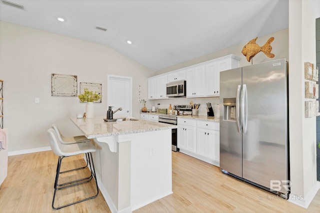 1203 Hayward Loop, Foley, AL 36535 - kitchen featuring a sink, visible vents, white cabinets, appliances with stainless steel finishes, and light wood-type flooring