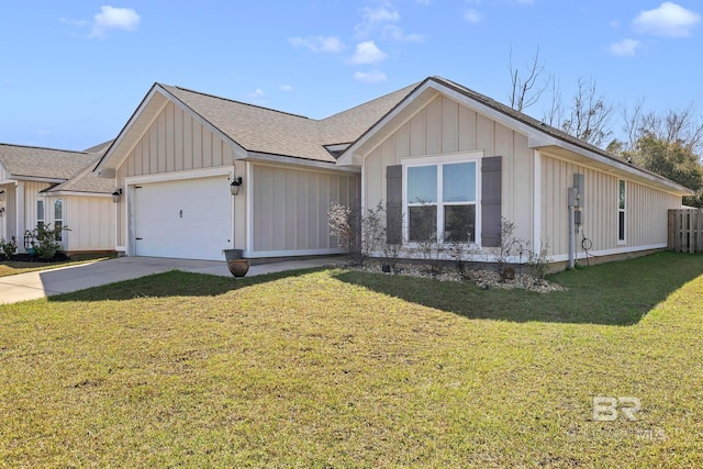 view of front of home with board and batten siding, a front lawn, driveway, and an attached garage