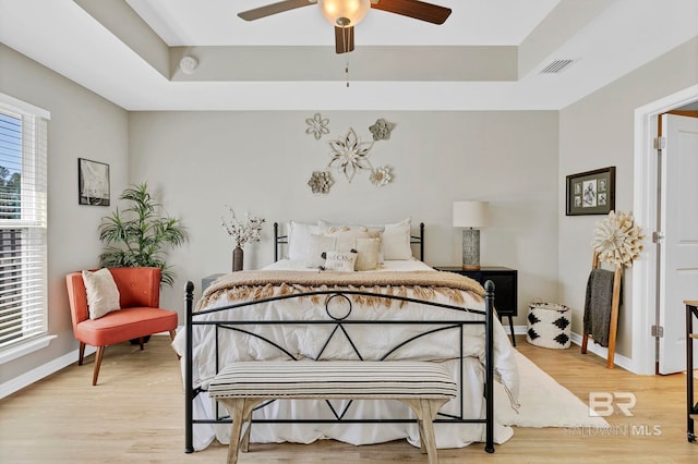 1203 Hayward Loop, Foley, AL 36535 - bedroom featuring light wood finished floors, a raised ceiling, visible vents, and baseboards