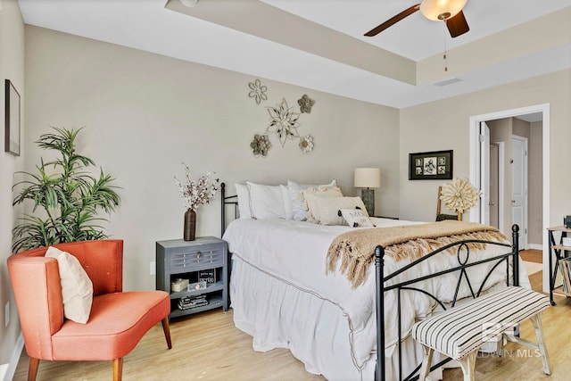 1203 Hayward Loop, Foley, AL 36535 - bedroom featuring a ceiling fan, a tray ceiling, visible vents, and light wood finished floors