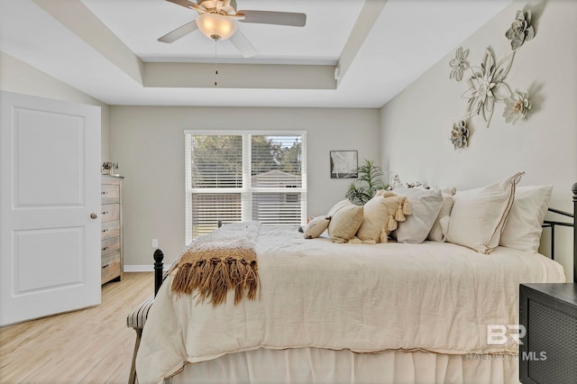 1203 Hayward Loop, Foley, AL 36535 - bedroom featuring ceiling fan, light wood-style flooring, baseboards, and a raised ceiling