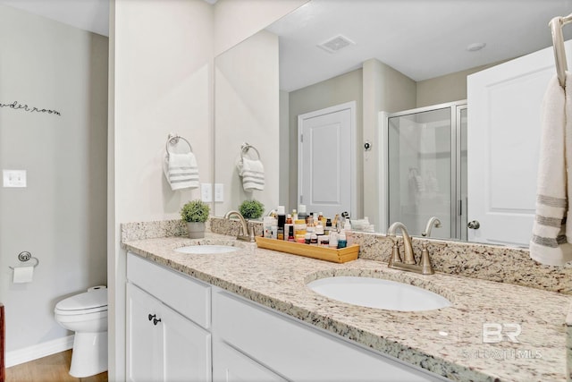 1203 Hayward Loop, Foley, AL 36535 - bathroom featuring toilet, a stall shower, visible vents, and a sink