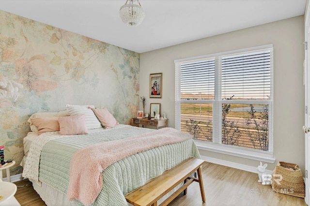 1203 Hayward Loop, Foley, AL 36535 - bedroom featuring wallpapered walls, wood finished floors, and baseboards