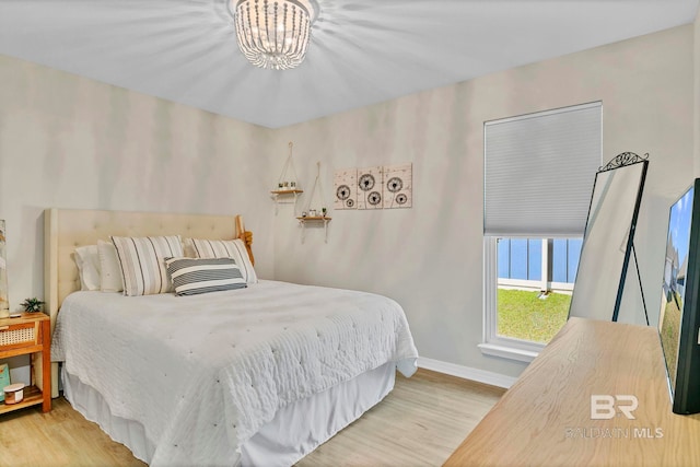 1203 Hayward Loop, Foley, AL 36535 - bedroom featuring a chandelier, wood finished floors, and baseboards