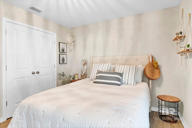 1203 Hayward Loop, Foley, AL 36535 - bedroom featuring baseboards, a closet, visible vents, and wood finished floors