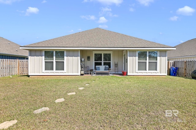 1203 Hayward Loop, Foley, AL 36535 - back of house with board and batten siding, roof with shingles, a yard, and fence