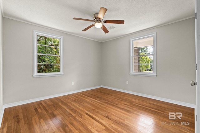 spare room with wood finished floors, baseboards, and ceiling fan