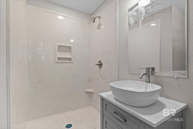 full bathroom featuring vanity and a shower