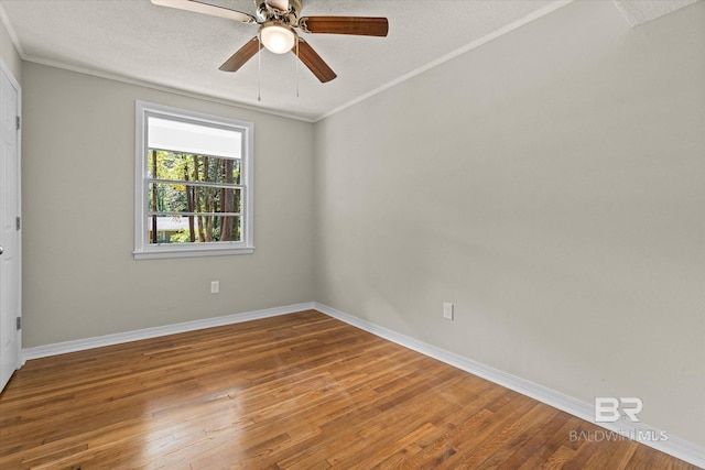 empty room featuring baseboards, wood finished floors, and a textured ceiling