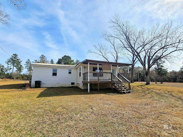 rear view of property with a lawn