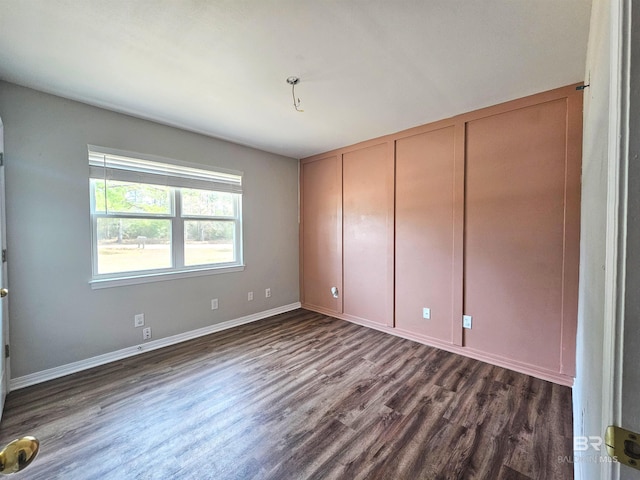 unfurnished bedroom featuring dark hardwood / wood-style flooring