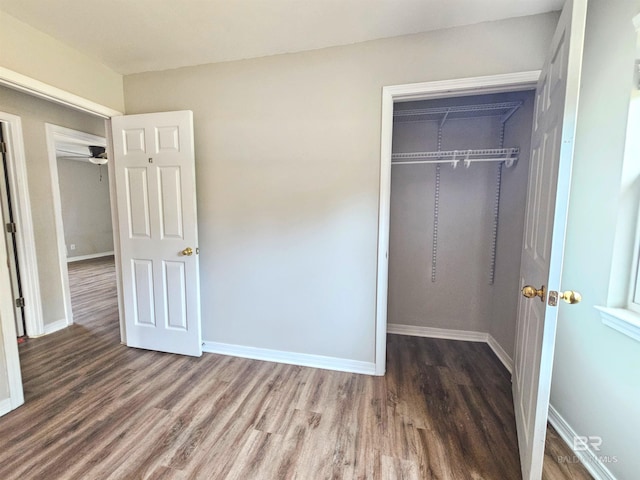 unfurnished bedroom with wood-type flooring and a closet