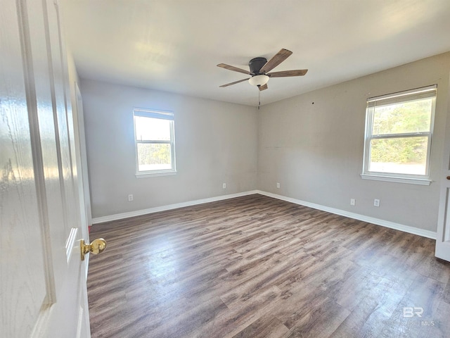 spare room with dark wood-type flooring and ceiling fan