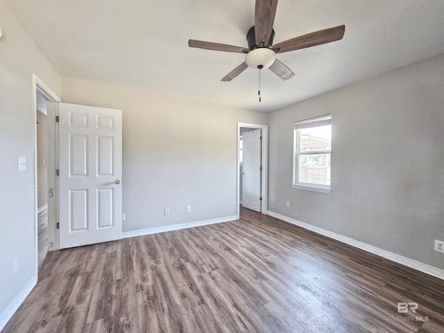 spare room featuring dark hardwood / wood-style flooring and ceiling fan