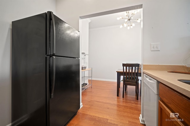 4 Yacht Club Dr Unit 174, Daphne, AL 36526 - kitchen with freestanding refrigerator, brown cabinets, white dishwasher, ornamental molding, and a chandelier