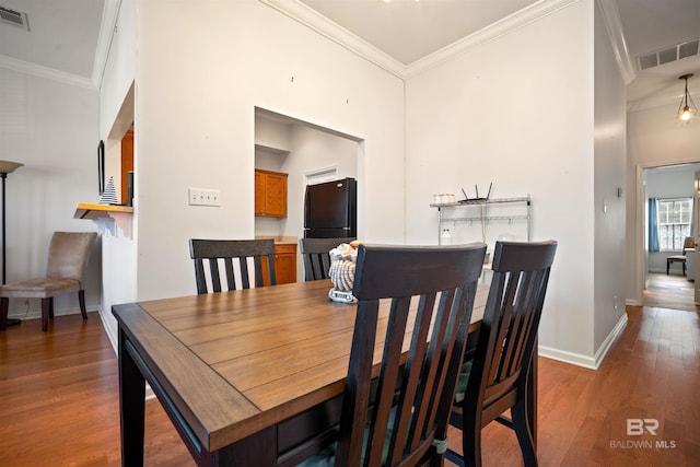 4 Yacht Club Dr Unit 174, Daphne, AL 36526 - dining room featuring wood finished floors, crown molding, and baseboards
