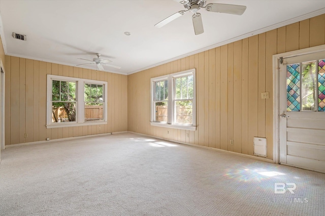 121 Westwood St, Mobile, AL 36606 - empty room with wooden walls, ceiling fan, ornamental molding, carpet flooring, and visible vents