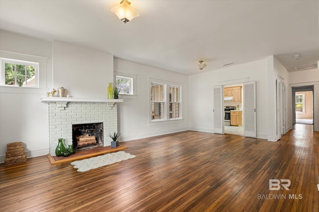 121 Westwood St, Mobile, AL 36606 - unfurnished living room with hardwood / wood-style floors, plenty of natural light, baseboards, and a fireplace