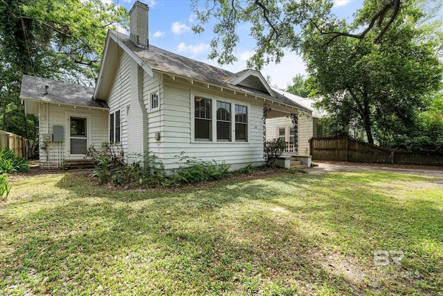 121 Westwood St, Mobile, AL 36606 - exterior space with a chimney, fence, and a lawn