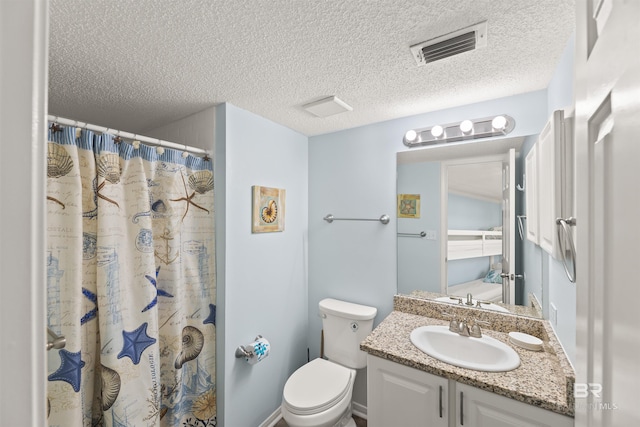 bathroom with toilet, a textured ceiling, walk in shower, and vanity