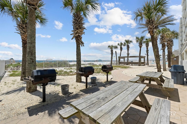 view of property's community featuring a patio and a water view