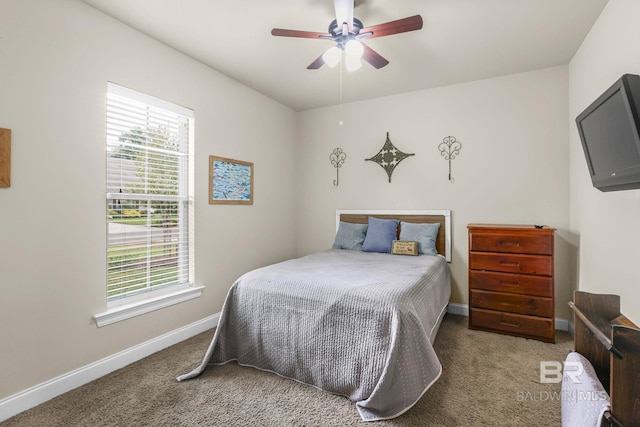 bedroom featuring multiple windows, carpet floors, and ceiling fan