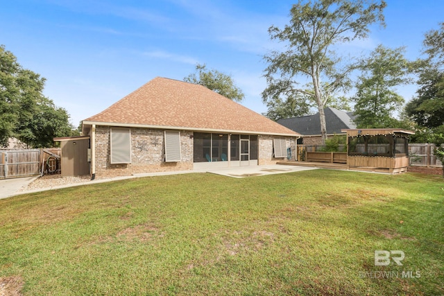 rear view of house featuring a yard and a patio