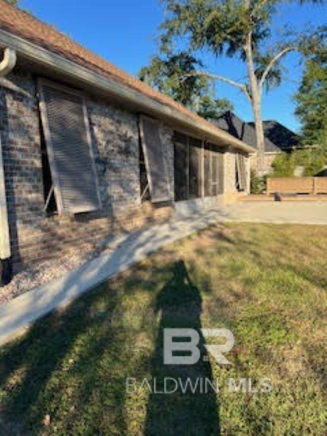 exterior space with a yard and a sunroom