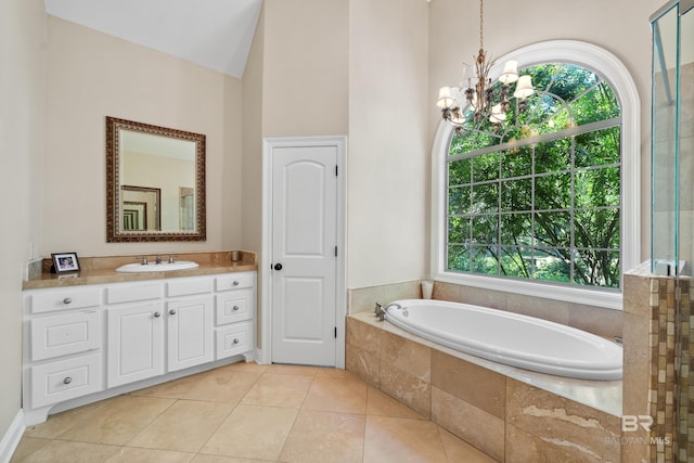 bathroom featuring a chandelier, vanity, plenty of natural light, and a bath