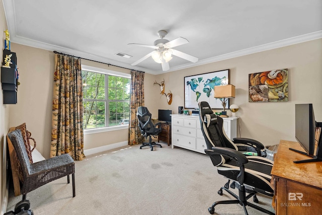 office featuring ornamental molding, light carpet, baseboards, visible vents, and a ceiling fan