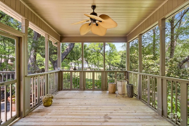 unfurnished sunroom with a ceiling fan